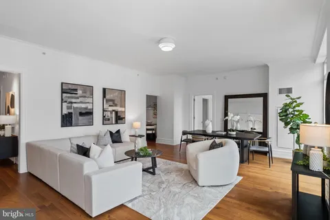 a living room with fireplace furniture and floor to ceiling window