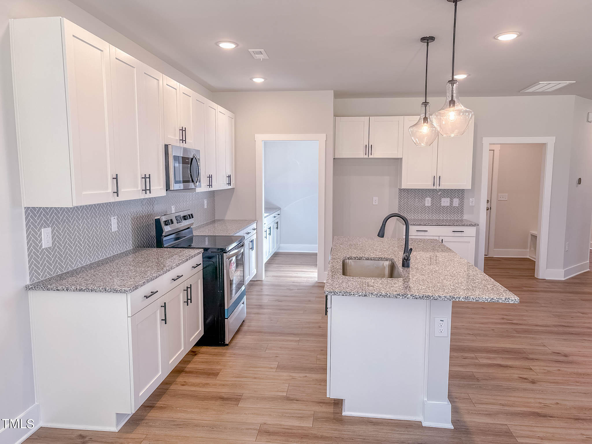 47 Beacon Hl Road, Unit SMITHFIELD Lillington, NC 27546 - Photo 13 of 69 a large kitchen with stainless steel appliances granite countertop a sink a stove and a refrigerator