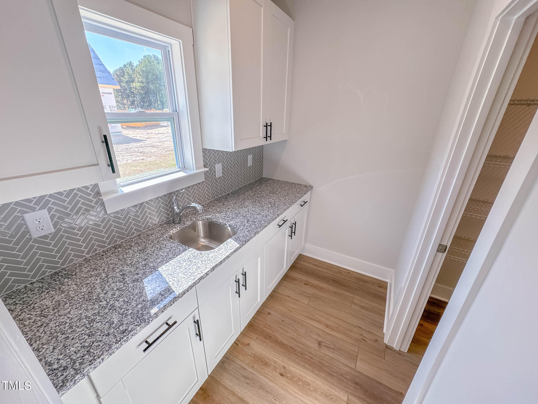 47 Beacon Hl Road, Unit SMITHFIELD Lillington, NC 27546 - Photo 15 of 69 a kitchen with stainless steel appliances granite countertop a sink and a wooden floor