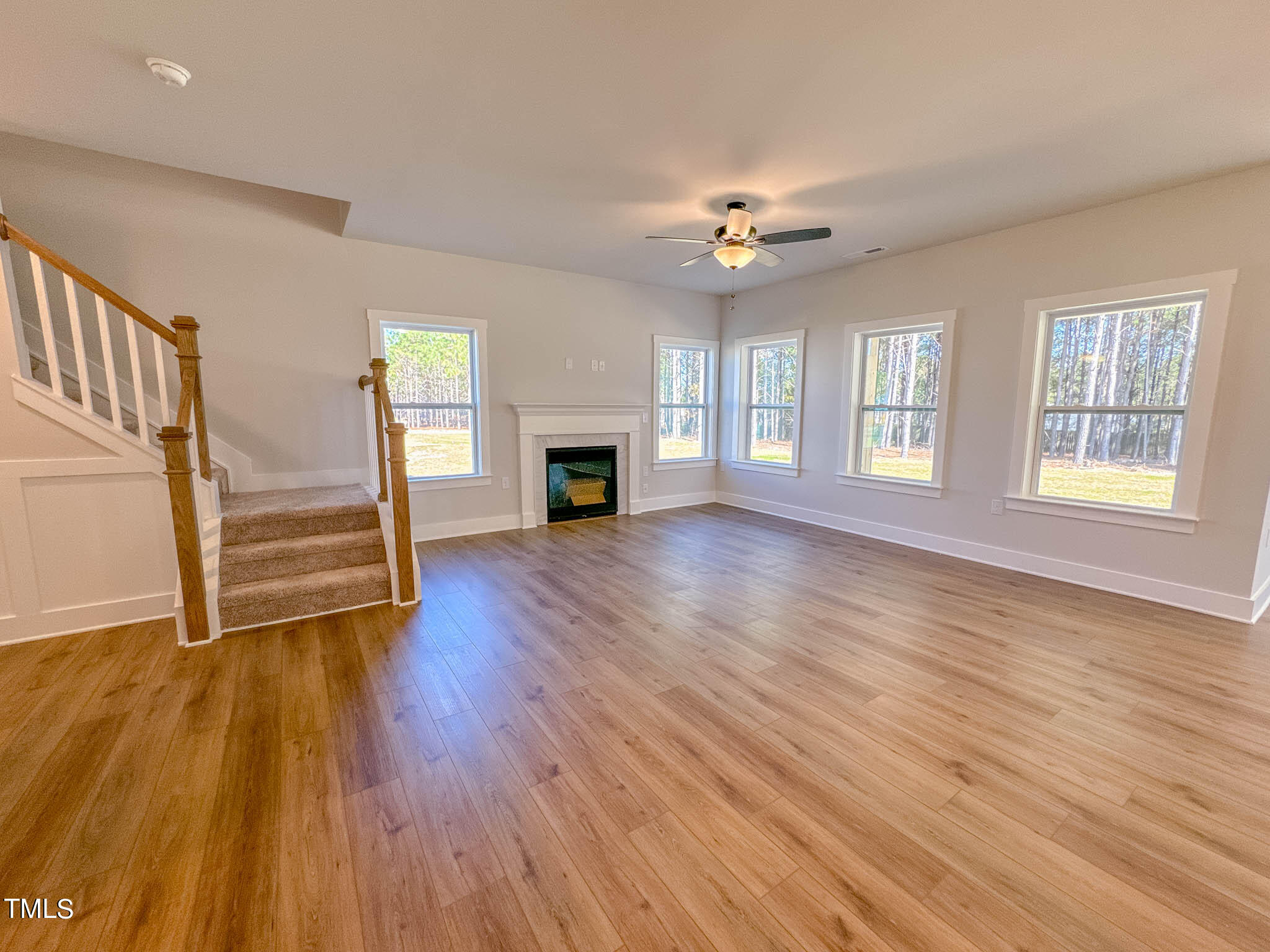 47 Beacon Hl Road, Unit SMITHFIELD Lillington, NC 27546 - Photo 24 of 69 an empty room with wooden floor fireplace and windows