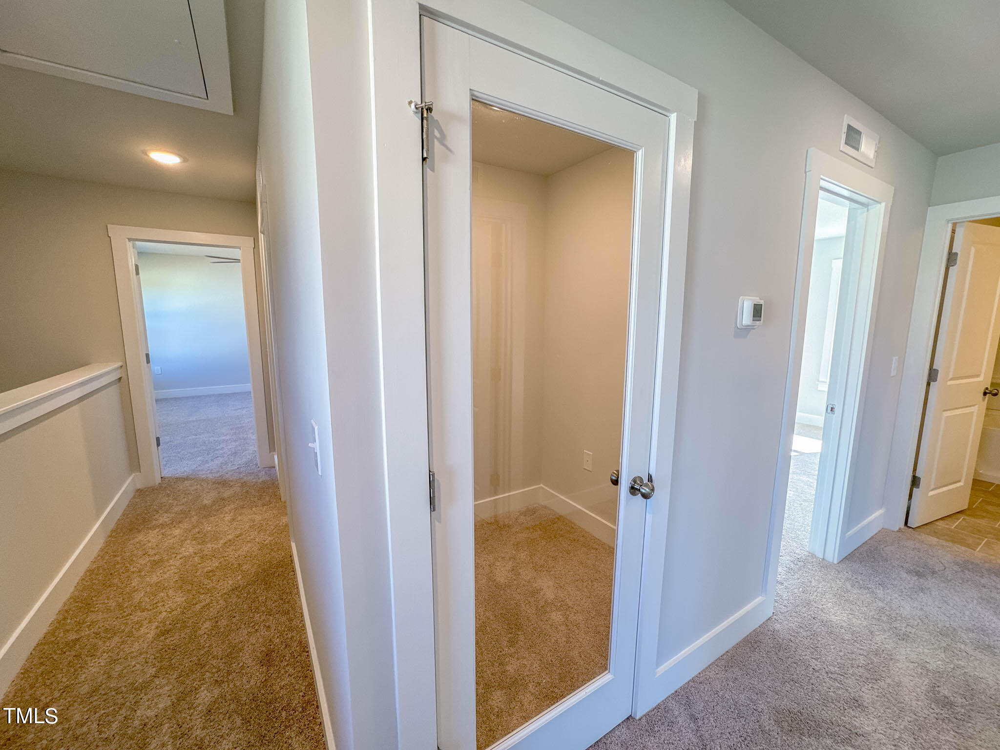 47 Beacon Hl Road, Unit SMITHFIELD Lillington, NC 27546 - Photo 29 of 69 a view of a bathroom from a corridor