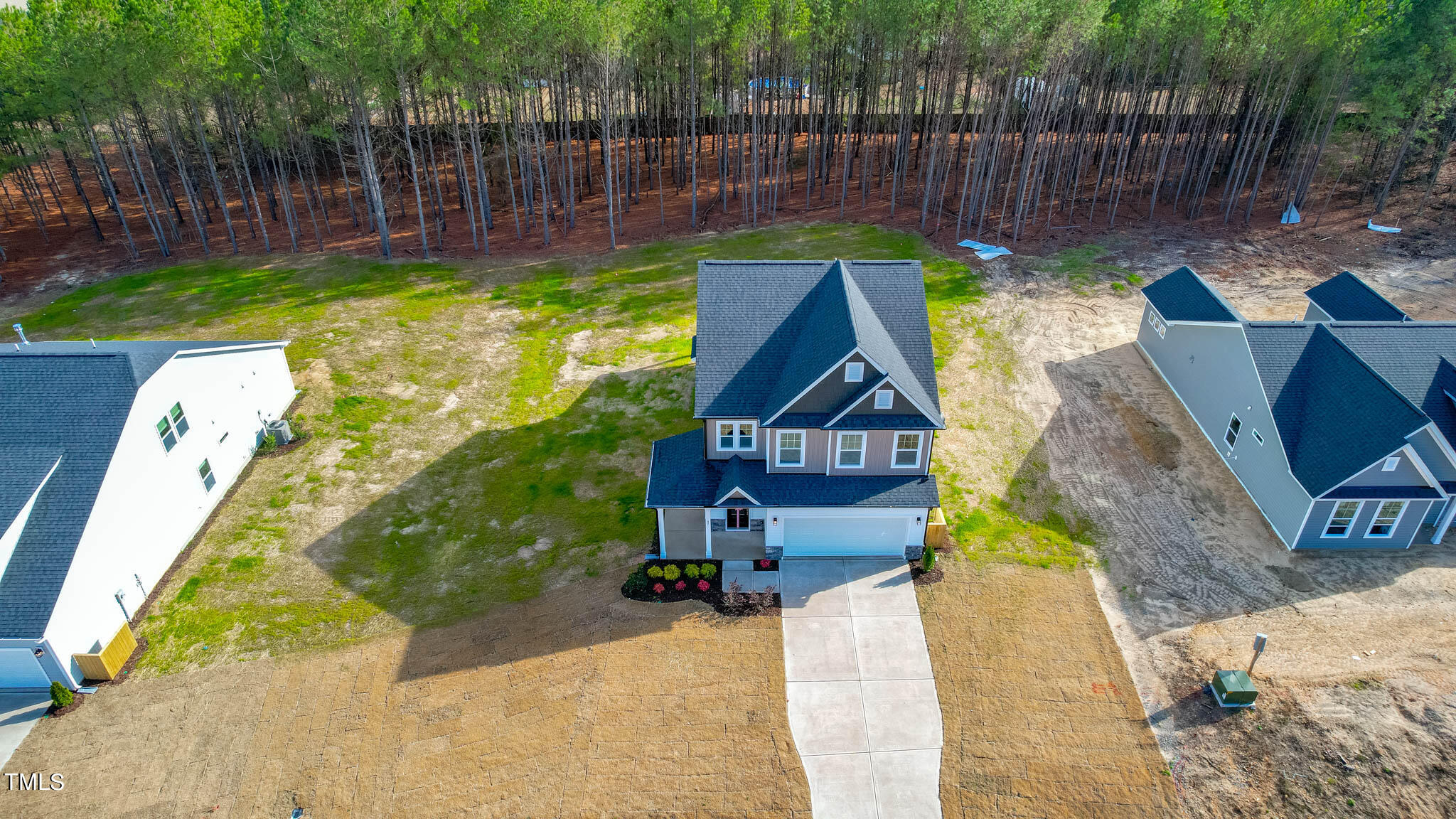 47 Beacon Hl Road, Unit SMITHFIELD Lillington, NC 27546 - Photo 3 of 69 a view of a backyard with plants and wooden fence