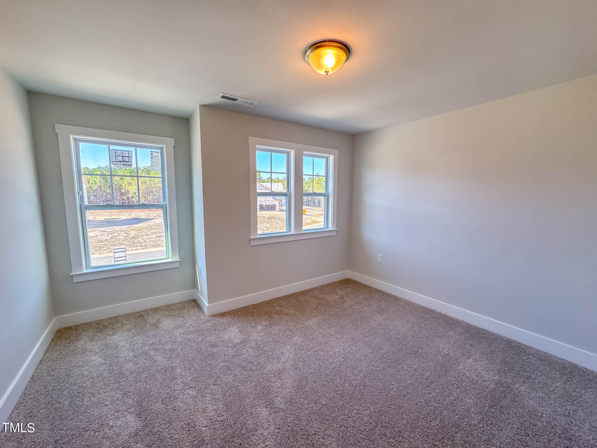 47 Beacon Hl Road, Unit SMITHFIELD Lillington, NC 27546 - Photo 33 of 69 an empty room with windows and mirror