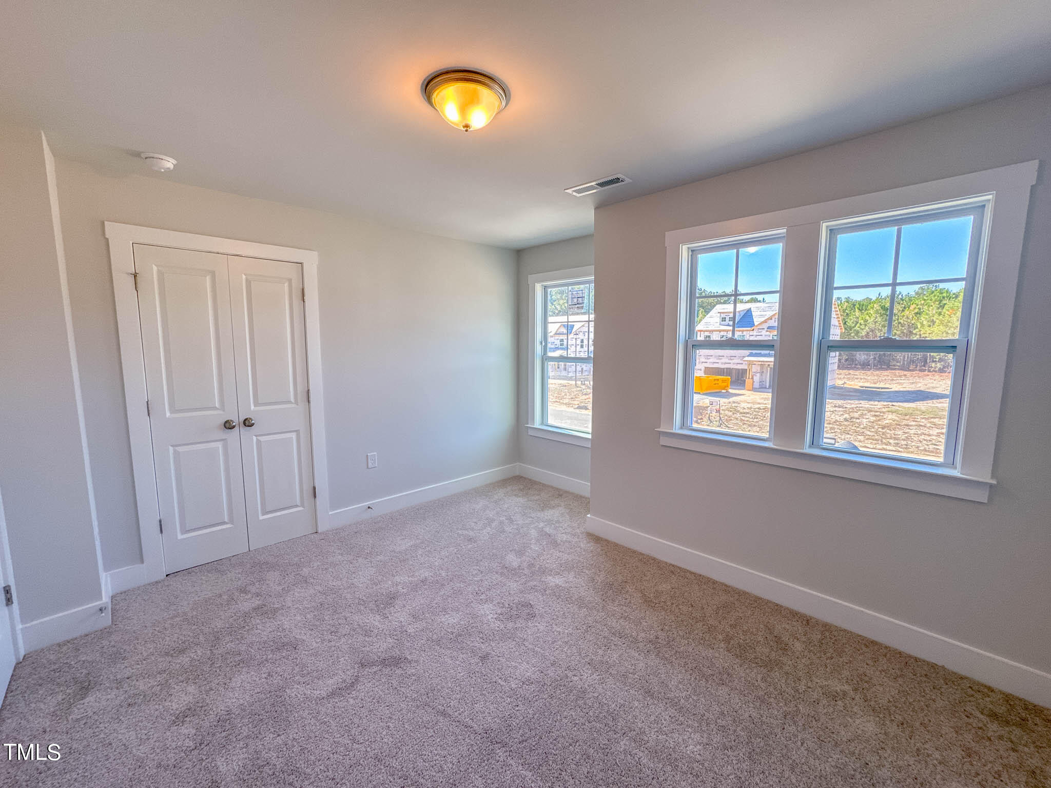 47 Beacon Hl Road, Unit SMITHFIELD Lillington, NC 27546 - Photo 35 of 69 an empty room with windows and closet