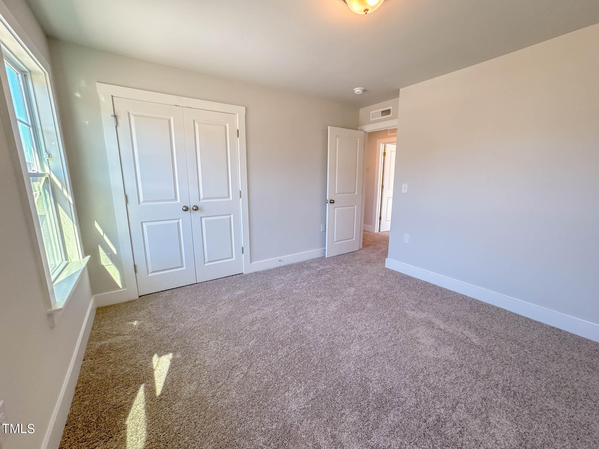 47 Beacon Hl Road, Unit SMITHFIELD Lillington, NC 27546 - Photo 40 of 69 a view of an empty room and window