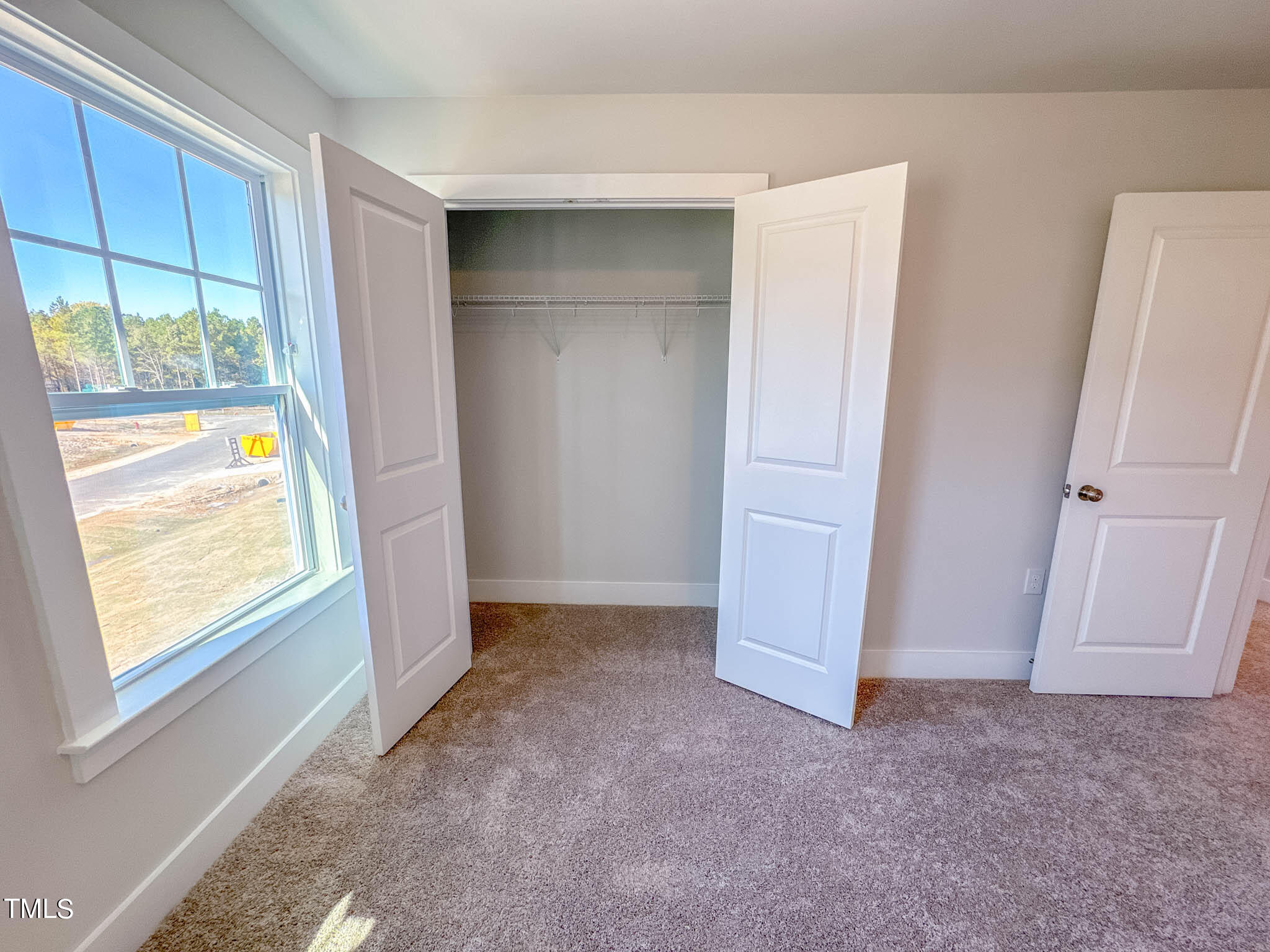 47 Beacon Hl Road, Unit SMITHFIELD Lillington, NC 27546 - Photo 42 of 69 an empty room with windows and closet