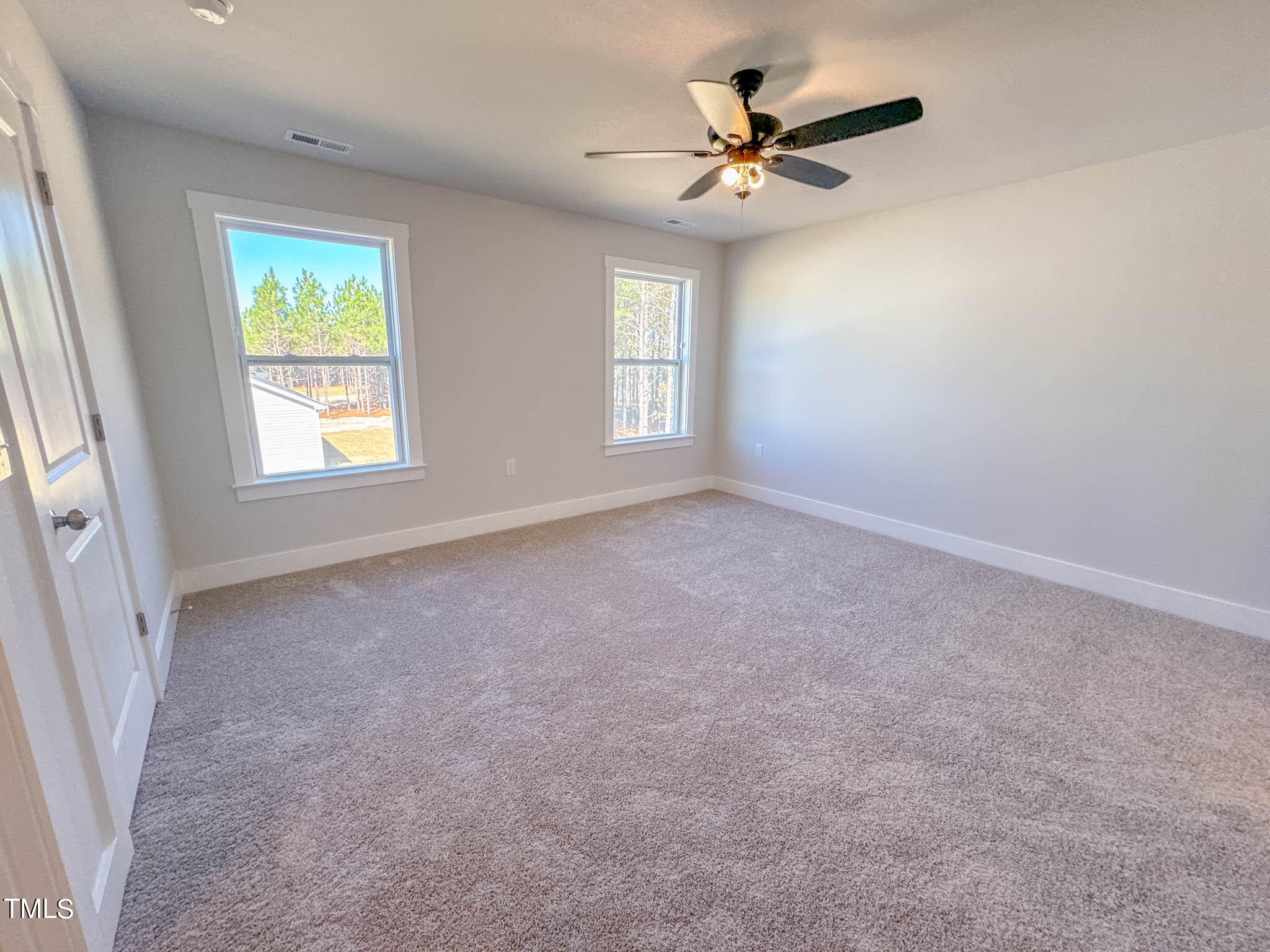 47 Beacon Hl Road, Unit SMITHFIELD Lillington, NC 27546 - Photo 55 of 69 an empty room with windows and fan