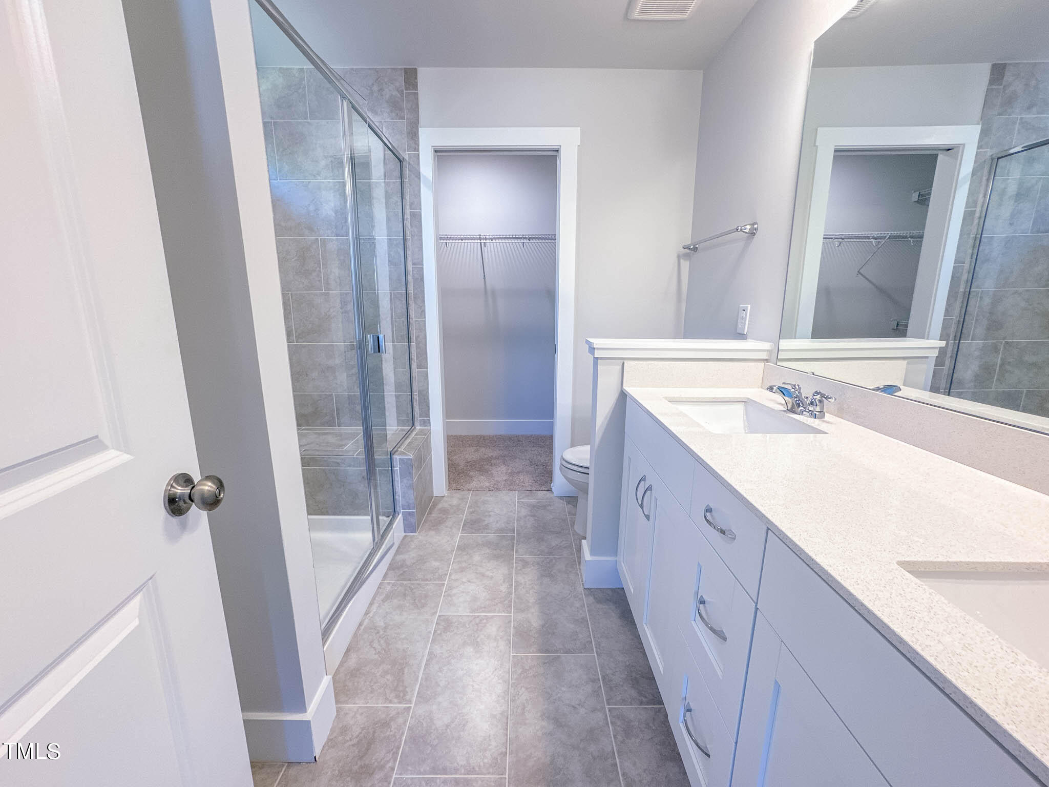47 Beacon Hl Road, Unit SMITHFIELD Lillington, NC 27546 - Photo 58 of 69 a spacious bathroom with a double vanity sink and a mirror
