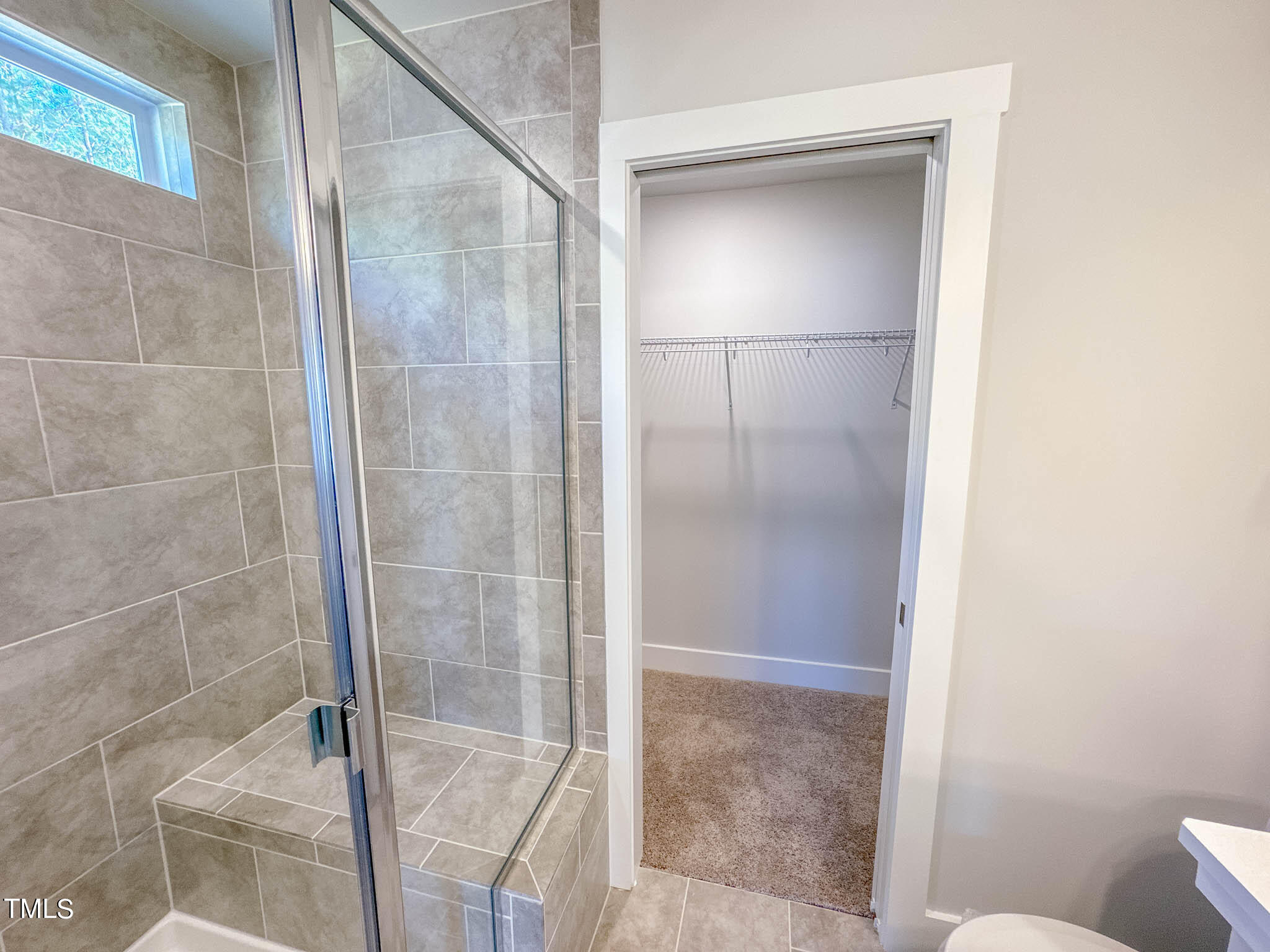 47 Beacon Hl Road, Unit SMITHFIELD Lillington, NC 27546 - Photo 63 of 69 a bathroom with a glass shower door