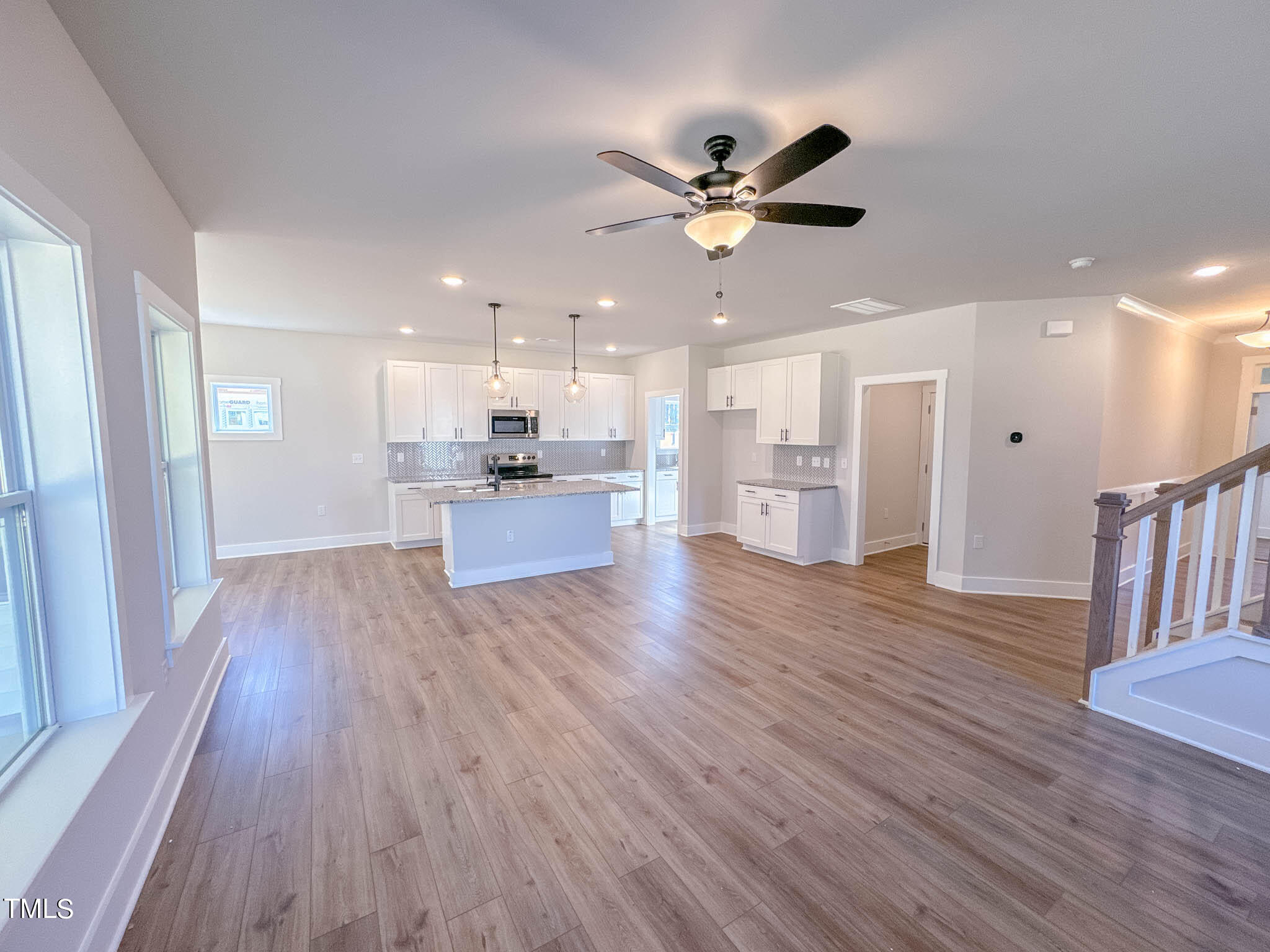47 Beacon Hl Road, Unit SMITHFIELD Lillington, NC 27546 - Photo 10 of 69 a view of an empty room and kitchen with wooden floor