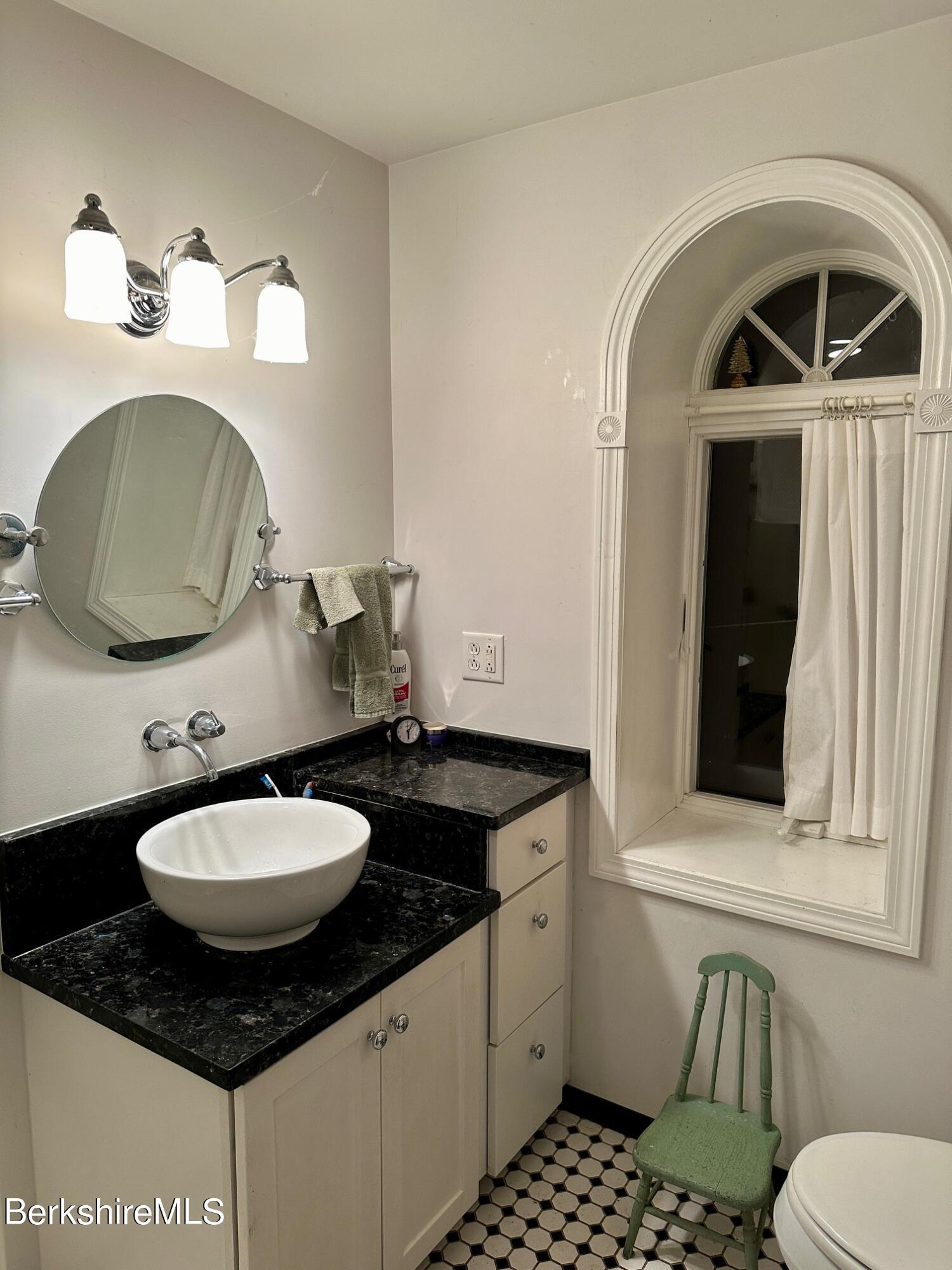 497 Dublin Road Richmond, MA 01201 - Photo 15 of 25 a bathroom with a granite countertop toilet sink and mirror
