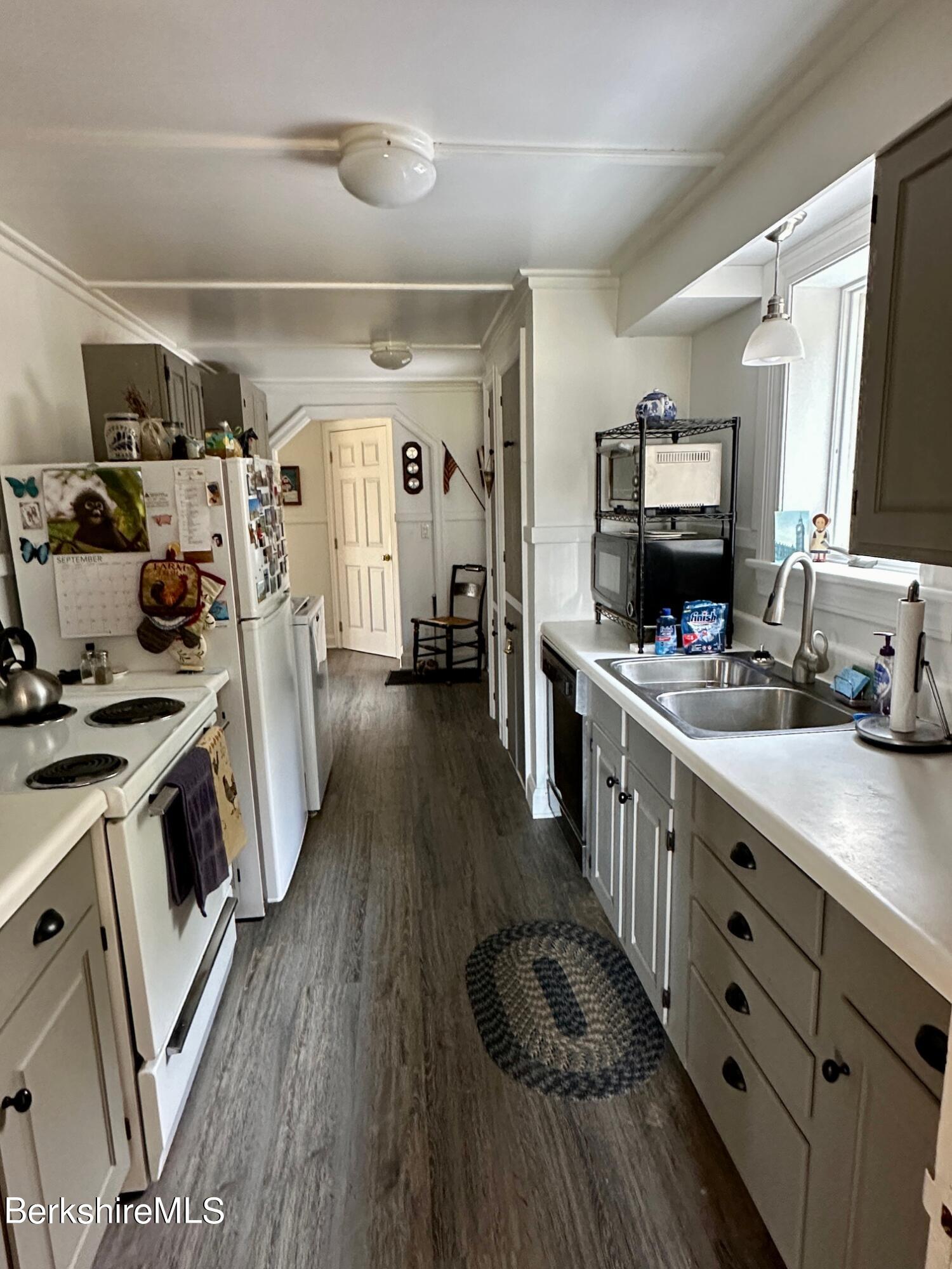 497 Dublin Road Richmond, MA 01201 - Photo 8 of 25 a kitchen with sink a stove and wooden floor