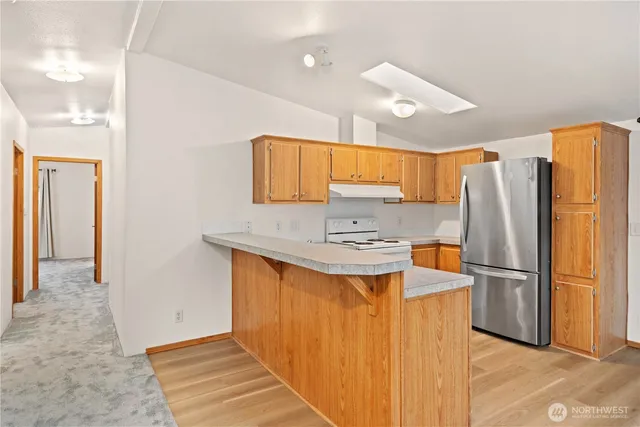 a kitchen with stainless steel appliances a refrigerator and a sink