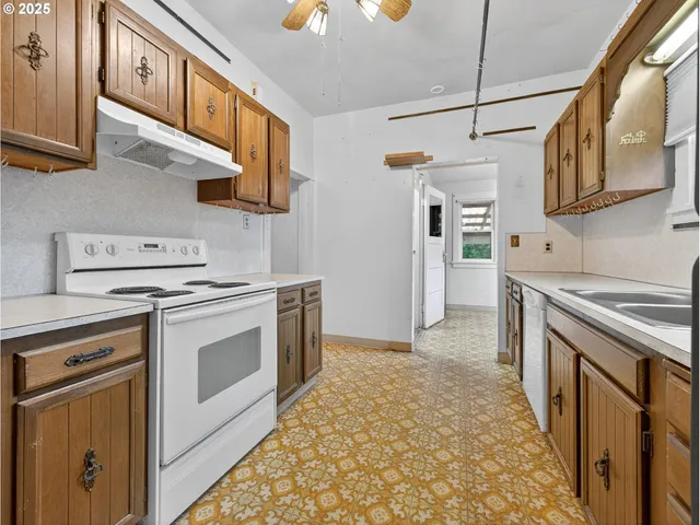 a kitchen with stainless steel appliances granite countertop a stove and a sink