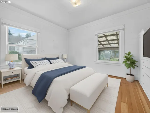 a bedroom with bed and a large window