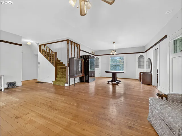 a view of hall way with furniture and floor to ceiling window