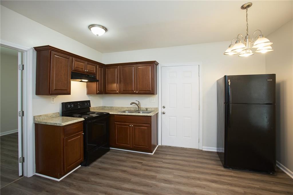 1049 Sims Street Southwest Atlanta, GA 30310 - Photo 2 of 9 a kitchen with stainless steel appliances granite countertop a refrigerator stove and microwave