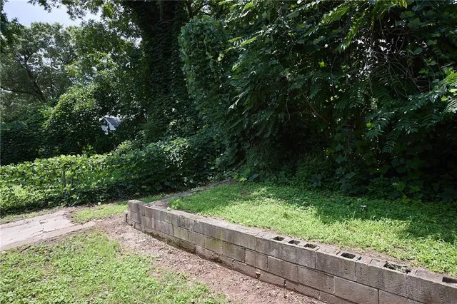 a view of a garden with wooden fence
