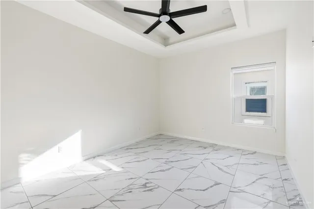 an empty room with fan and entryway