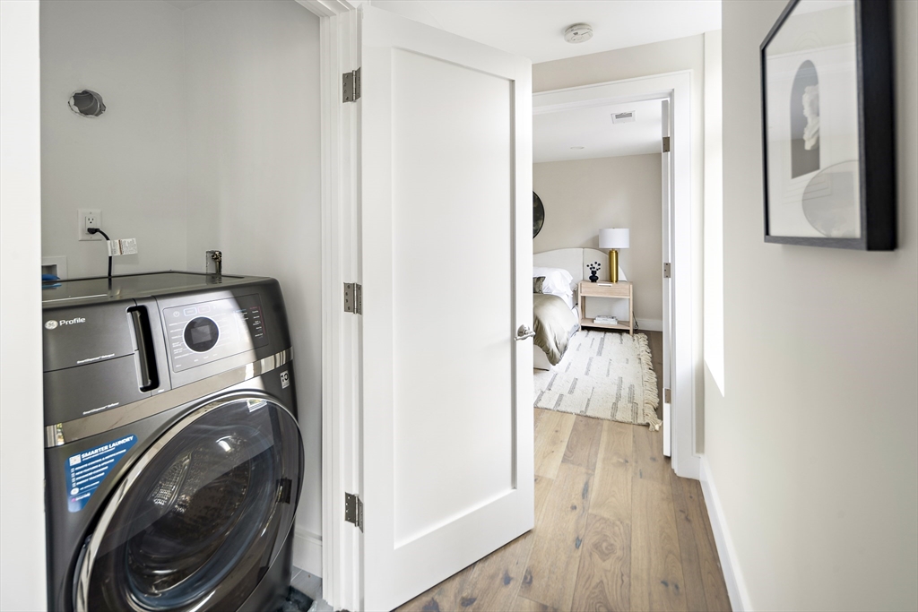 20 Kinmonth Road, Unit 201 Newton, MA 02468 - Photo 24 of 33 a view of a hallway with washer and dryer