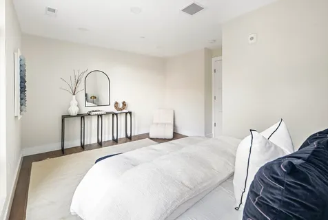 a bedroom with a bed and a sink