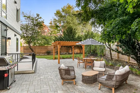 a patio with patio a table and chairs under an umbrella