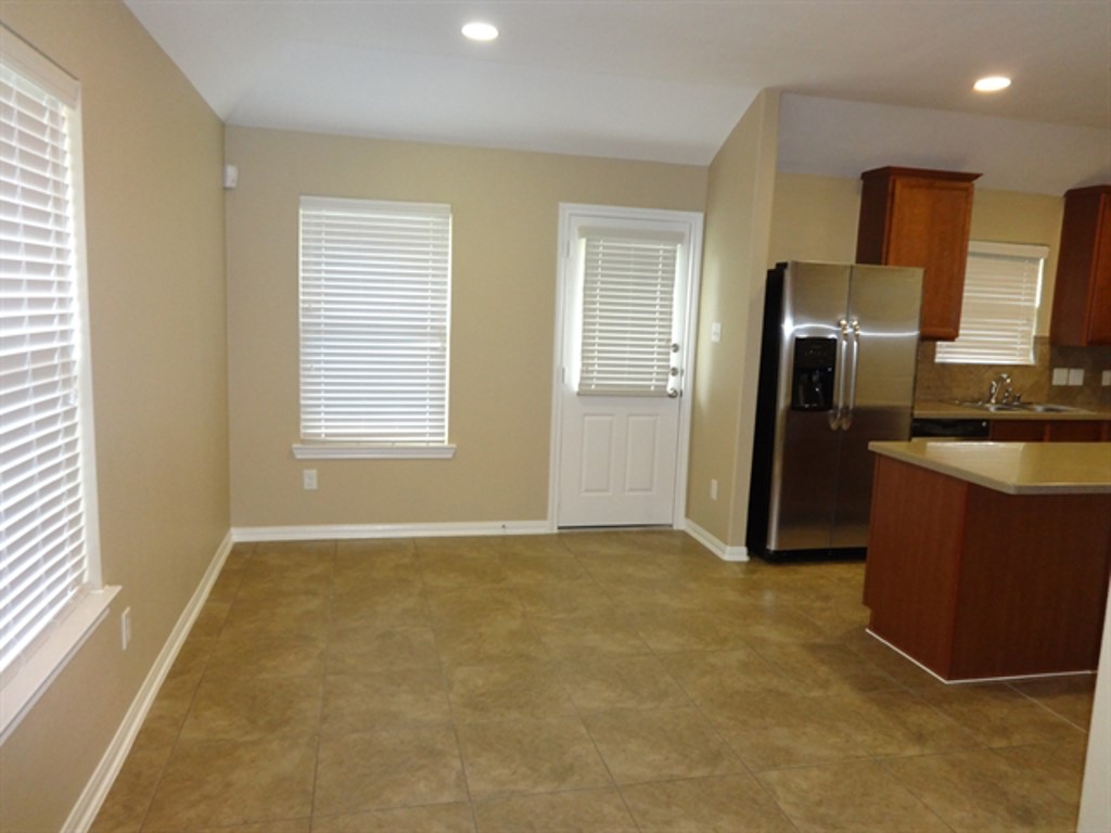 5318 Rio Drive Baytown, TX 77521 - Photo 3 of 11 an empty room with a fireplace and a window