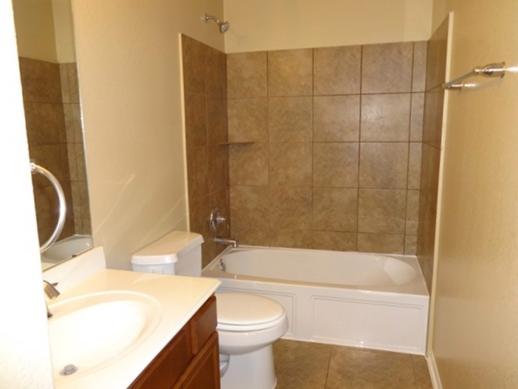 5318 Rio Drive Baytown, TX 77521 - Photo 8 of 11 a bathroom with a sink a toilet and a bathtub