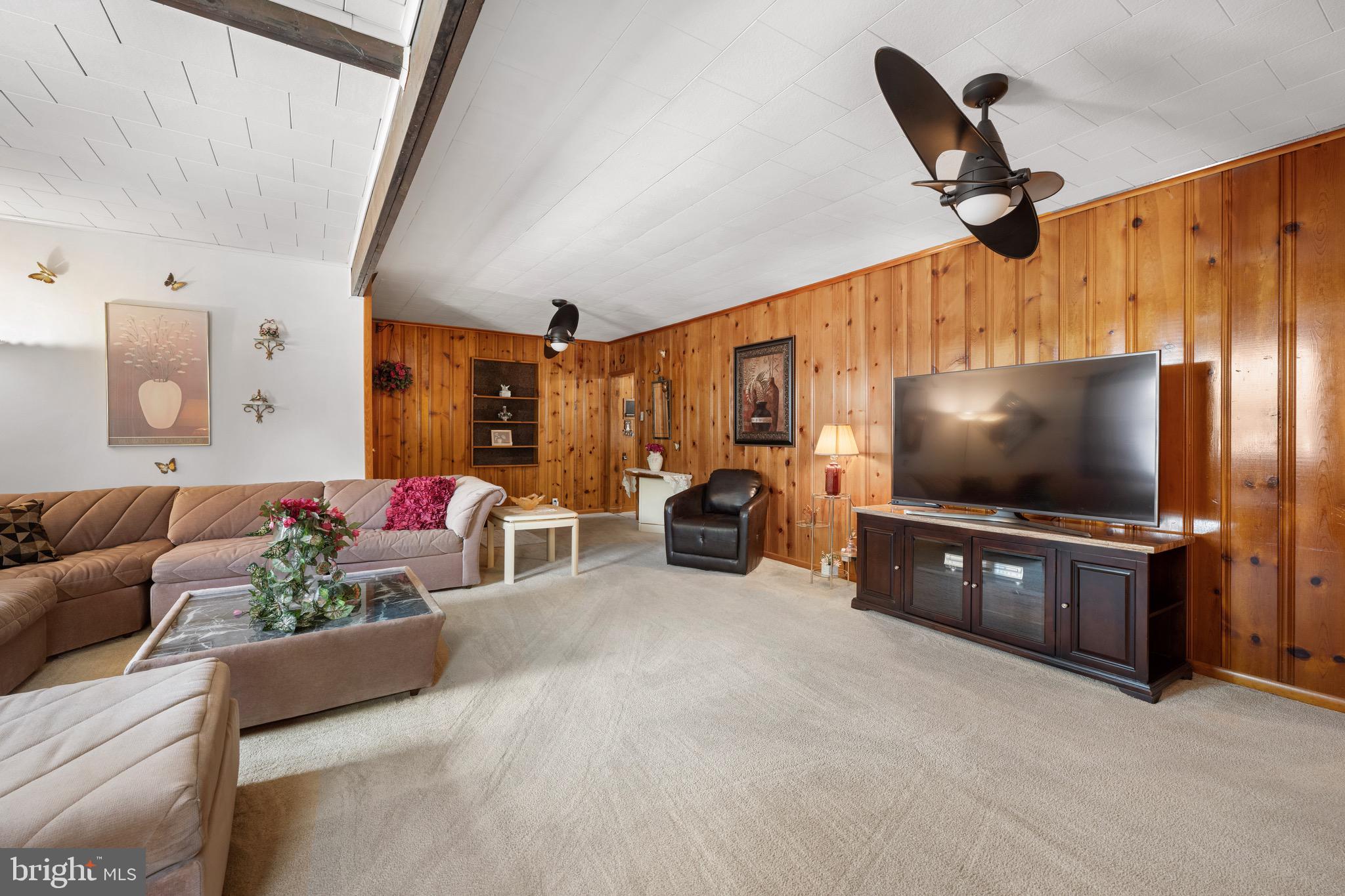 302 Tyler Avenue Carneys Point, NJ 08069 - Photo 6 of 27 a living room with furniture and a flat screen tv