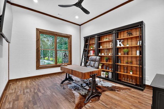 a kitchen with granite countertop stainless steel appliances and wooden floor