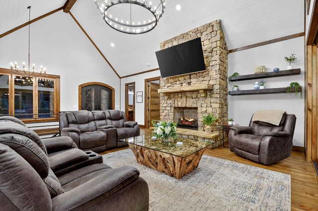 a kitchen with granite countertop stainless steel appliances and wooden floor