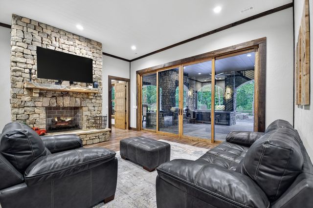 a living room with patio furniture and a floor to ceiling window