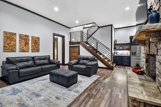a living room with furniture a flat screen tv and a fireplace