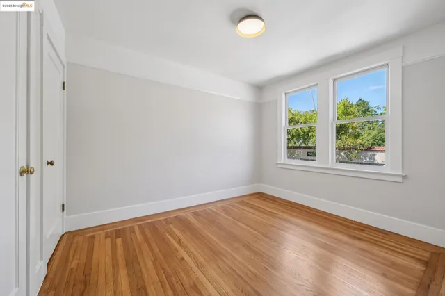 a view of room with window and hardwood floor
