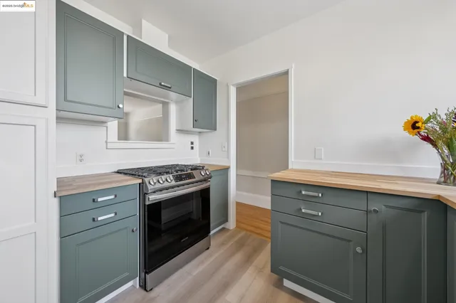 a kitchen with a stove and cabinets