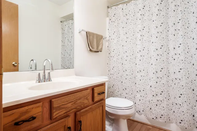 a bathroom with a sink a toilet and a mirror