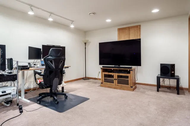 a view of a livingroom with workspace and a window
