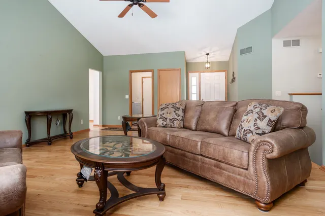 a living room with furniture and a wooden floor