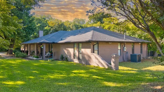 a view of a house with a yard and sitting area