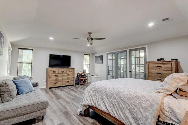 a bedroom with a bed and a flat screen tv