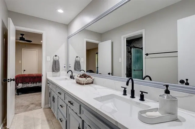 a bathroom with a double vanity sink and a mirror