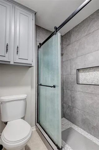 a white toilet sitting next to a bathroom