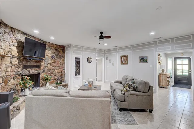 a living room with fireplace furniture and a flat screen tv