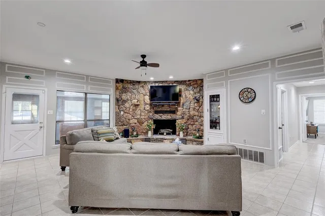 a living room with furniture and a fireplace