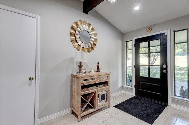 a view of a hallway to a livingroom with furniture