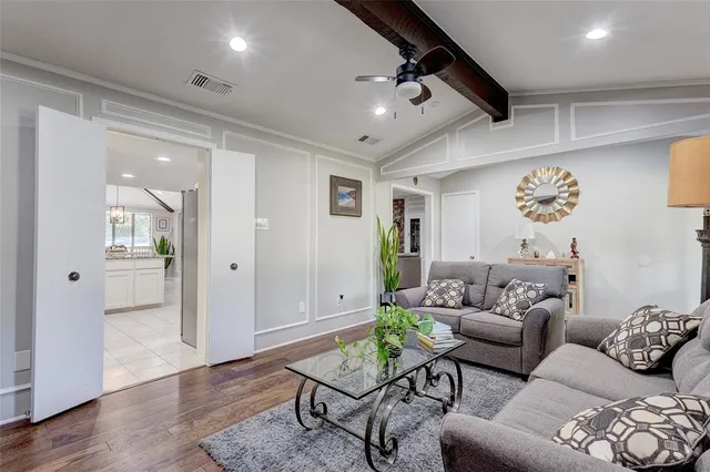 a living room with furniture and wooden floor