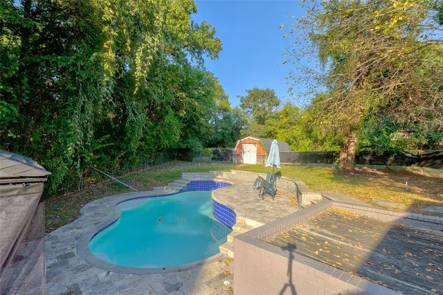 a view of a swimming pool with a patio