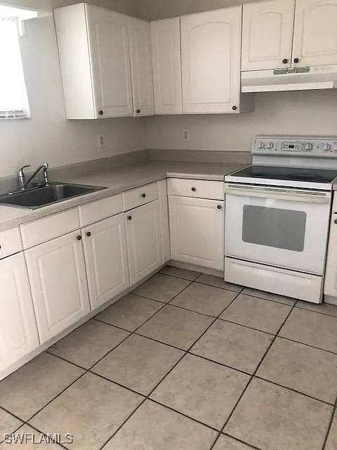 11216 Pendleton Avenue, Unit B Englewood, FL 34224 - Photo 8 of 10 a kitchen with cabinets and appliances