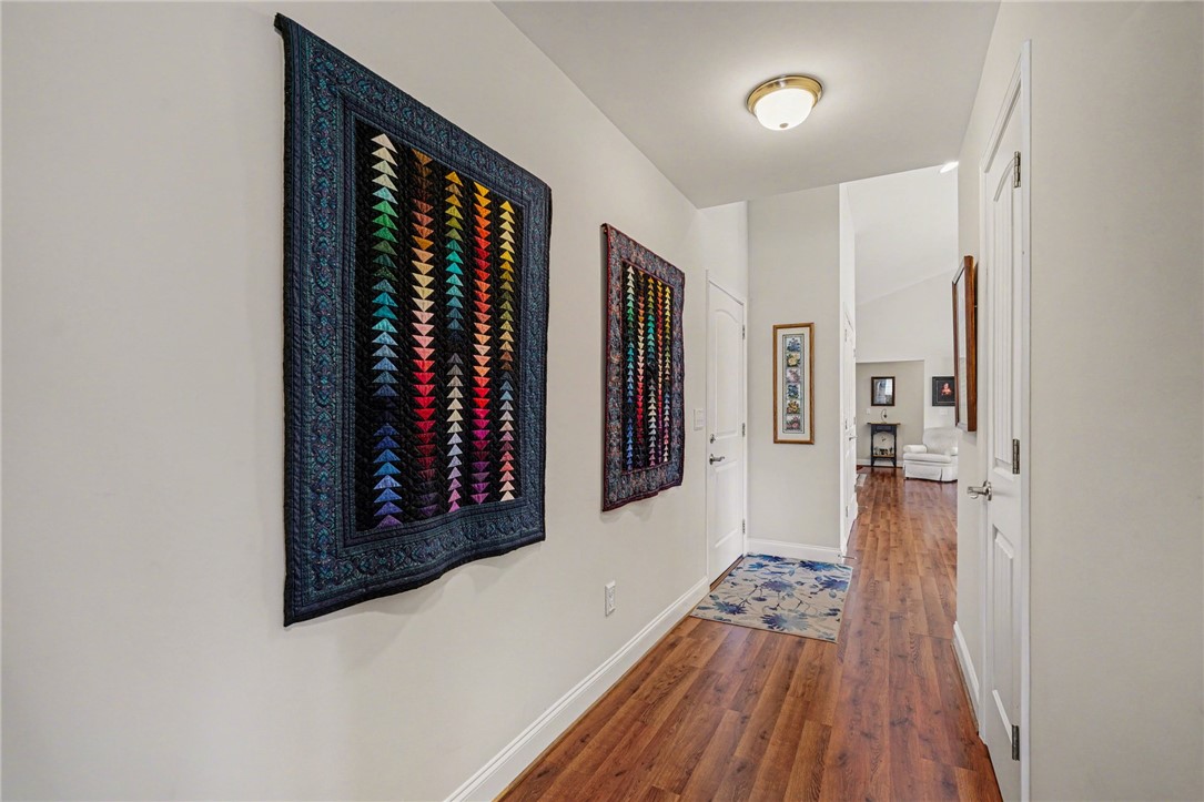 125 Apple Grove Drive Inman, SC 29349 - Photo 14 of 19 This spacious hallway features rich hardwood flooring leading to inviting living spaces.