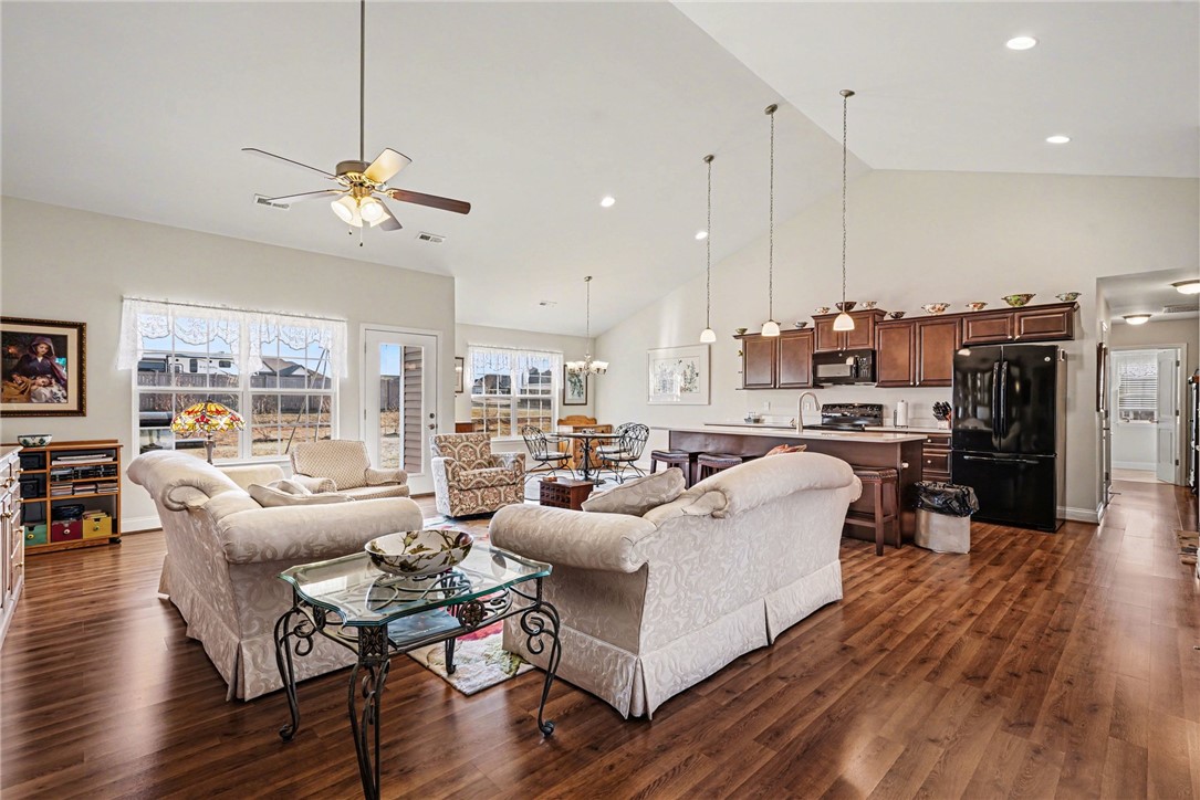 125 Apple Grove Drive Inman, SC 29349 - Photo 5 of 19 This inviting space combines living, dining, and kitchen areas with vaulted ceilings and warm wood floors.